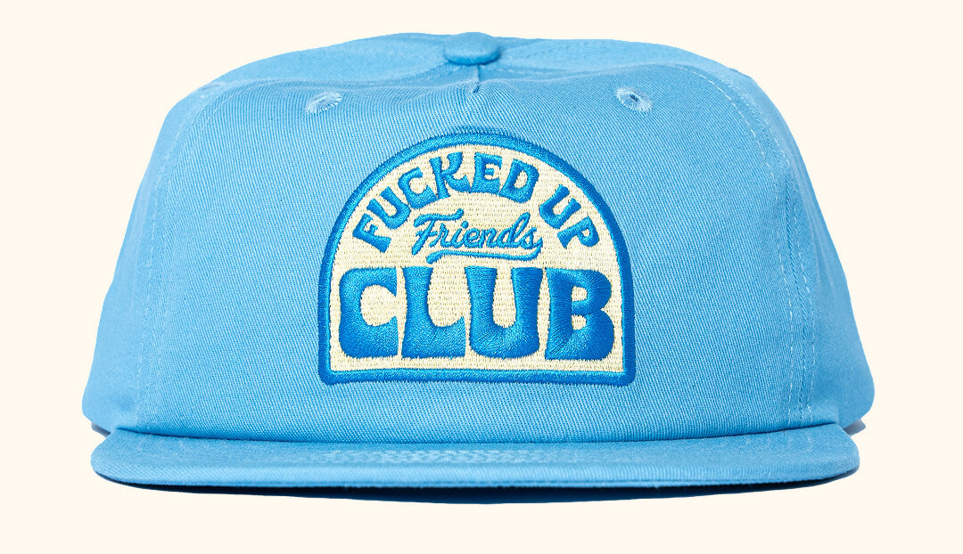 Light blue snapback cap with 'Fucked Up Friends Club' text embroidered on the front